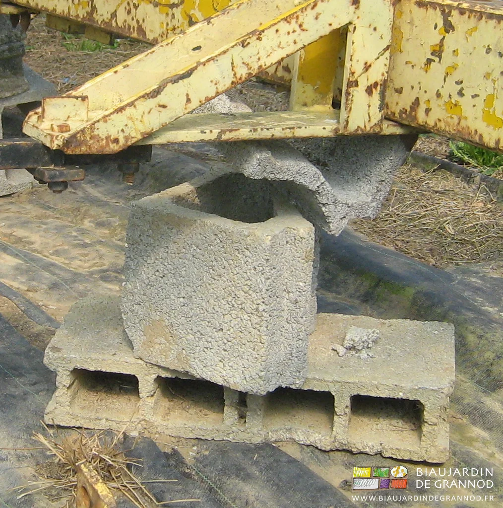 photo de barre jaune posée sur une pile de moellons et morceaux de moellon